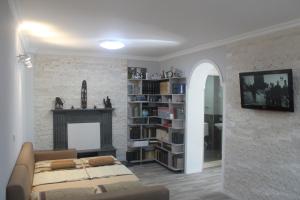 a living room with a bed and a fireplace at Deluxe Family Stay Near The Beach in Kvariati