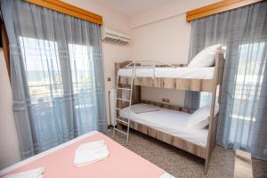 a room with two bunk beds and a table at Azura Studios in Stavros