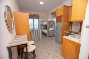a small kitchen with a sink and a room with a bed at Azura Studios in Stavros +37 photos