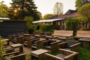 a group of benches and tables in a yard at Tiny House nearby Spa Francorchamps in Amblève +8 photos