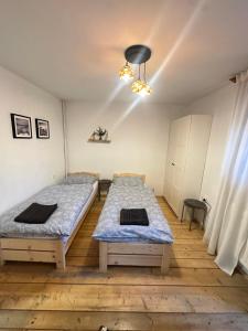 a bedroom with two beds and a ceiling at Dom Pod Lasem in Korbielów