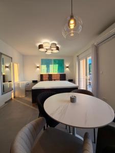 a room with a bed and a table and chairs at Apartman Blaga in Povlja
