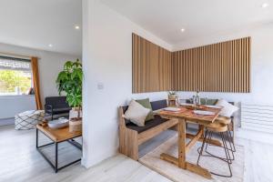 a dining room with a wooden table and chairs at 11 Dune View in Braunton +44 photos