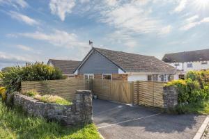 a house with a wooden fence in front of it at 11 Dune View in Braunton
