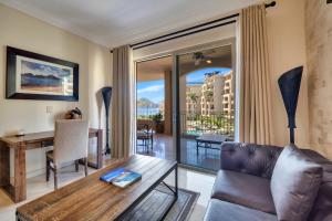 a living room with a couch and a table at Villa La Estancia - Medano Beach Villas in Cabo San Lucas