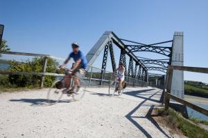 two people riding their bikes on a bridge at 2 Bed in Padstow oc-p00876 in Padstow