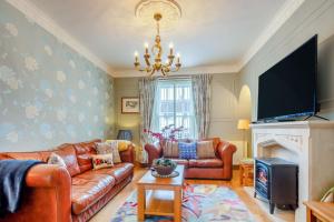 a living room with a couch and a fire place at 3 Bed in Aberaeron oc-86578 in Aberaeron