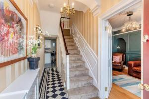 a hallway with stairs in a home with a chandelier at 3 Bed in Aberaeron oc-86578 in Aberaeron