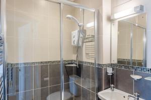 a bathroom with a shower and a sink at 3 Bed in Aberaeron oc-86578 in Aberaeron +21 photos