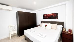 a bedroom with a large bed with white sheets at Mar, terraza y parking in Santa Pola