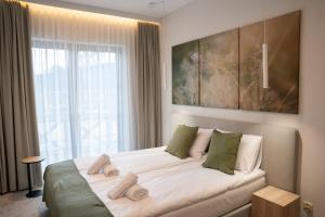 a bedroom with a large bed with a large window at Marina Piaski Apartamenty in Piaski +42 photos