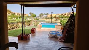 a patio with a view of a swimming pool at Mountain View 1 /Ain El Sokhna in Ain Sokhna