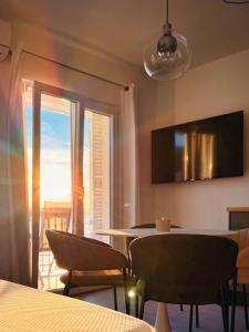 a dining room with a table and chairs and a window at Apartman Blaga in Povlja