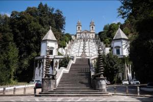 a large white building with stairs leading up to it at Diamante house com garagem privada in Braga
