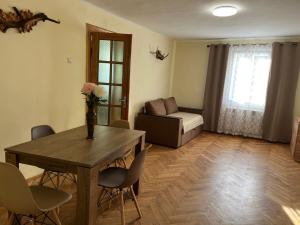 a living room with a table and chairs and a couch at Сколе Серце Карпат in Skole