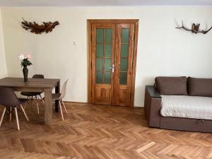a living room with a table and a couch at Сколе Серце Карпат in Skole +1 photo