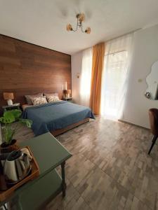 a bedroom with a bed with a wooden wall at Solmara in Lozenets