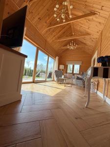 a large living room with wooden ceilings and a fireplace at Luna House in Łoje