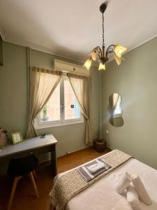 a bedroom with a bed and a desk and a window at Oscar - City Center Rooms Athens in Athens