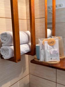 a pile of towels on a shelf in a bathroom at Vila Viorica in Mamaia Sat/Năvodari +147 photos