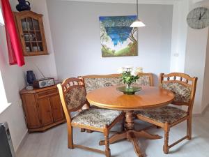 a dining room table and chairs with a vase of flowers at Ferienhaus Figelski in Sassnitz