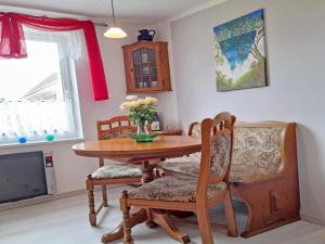 a dining room with a wooden table and chairs at Ferienhaus Figelski in Sassnitz