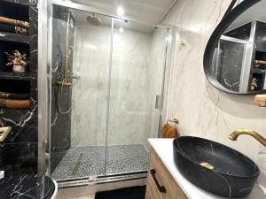 a bathroom with a shower and a black sink at La Pinède Bleue in Saint-Mandrier-sur-Mer +9 photos