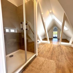 a bathroom with a shower in the attic at Käpitänshaus zum Plümper in Ahrenshoop +39 photos