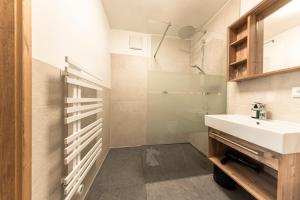 a bathroom with a sink and a shower at Beim Franz in Lermoos +64 photos
