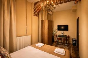 a bedroom with a bed and a table with chairs at Maison BERTHELOT in Bucharest