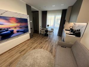 a living room with a large painting on the wall at Cozy Home Oasis in Palanga