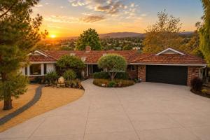 a house with a driveway in front of a sunset at Spacious Villa Private Gameroom in Fallbrook