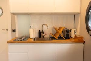 a kitchen with a sink and a counter top at Solina Houseboat Polańczyk in Polańczyk +19 photos