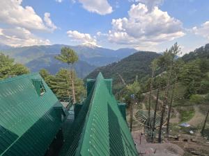 a room with a green roof with mountains in the background at Dar Al Masyaf in Sharan +8 photos