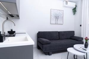 a living room with a couch and a sink at Agias Sofias Luxury Apartments in Thessaloniki +45 photos