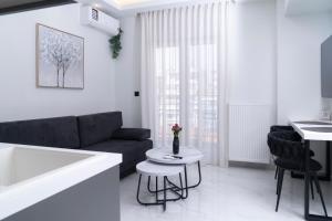 a living room with a couch and a table at Agias Sofias Luxury Apartments in Thessaloniki
