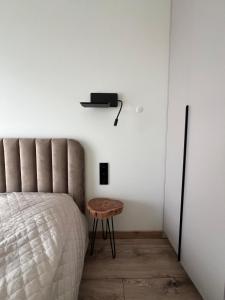 a bedroom with a bed and a small table at Cozy Home Oasis in Palanga +8 photos