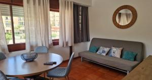 a living room with a couch and a table at Varinos House Praia in Alvor