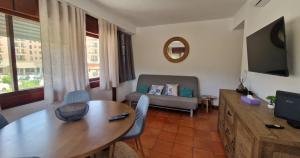 a living room with a table and a couch at Varinos House Praia in Alvor