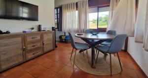 a kitchen with a table and chairs in a room at Varinos House Praia in Alvor