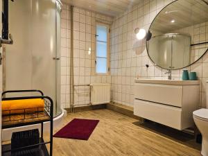 a bathroom with a tub and a sink and a mirror at B5 Jurmala Apartments in Jūrmala +36 photos