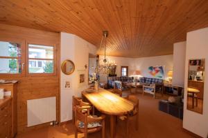 a living room with a wooden ceiling at Schweizerhof Drescher 612 in Lenzerheide