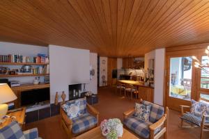 a living room with a wooden ceiling at Schweizerhof Drescher 612 in Lenzerheide