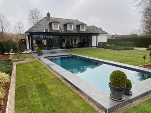 a house with a swimming pool in the yard at Nachtegaal in Dilsen-Stokkem