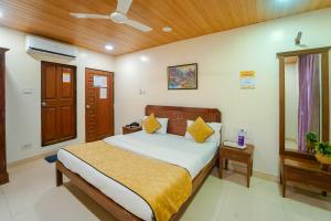 a bedroom with a large bed and a mirror at The New Hill Retreat in Mahabaleshwar