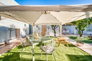 a patio with a table and chairs under an umbrella at Kalamoti Suites in Kalamoti
