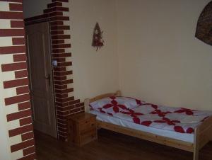 a bedroom with a bed and a dresser at Penzion U červených vrat in Chudolazy