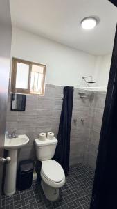 a bathroom with a toilet and a sink at Departamento scorpio in Tuxtla Gutiérrez +22 photos