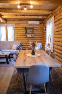 a dining room with a table and chairs at Brvnara Vasić - Stara planina in Pirot +14 photos