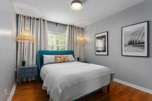 a bedroom with a bed and two chandeliers at Plaza Condo With Queen Bed 3 in Kansas City